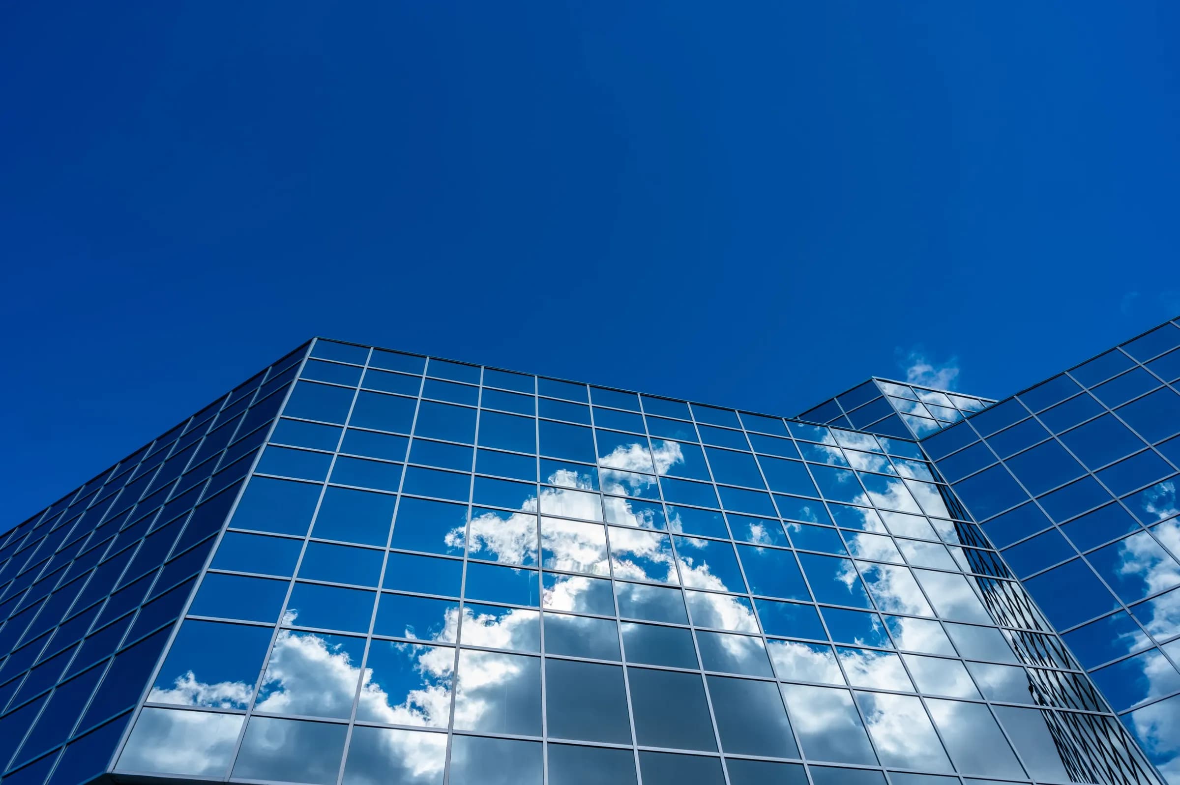 Clouds reflected in the glass facade of an office tower