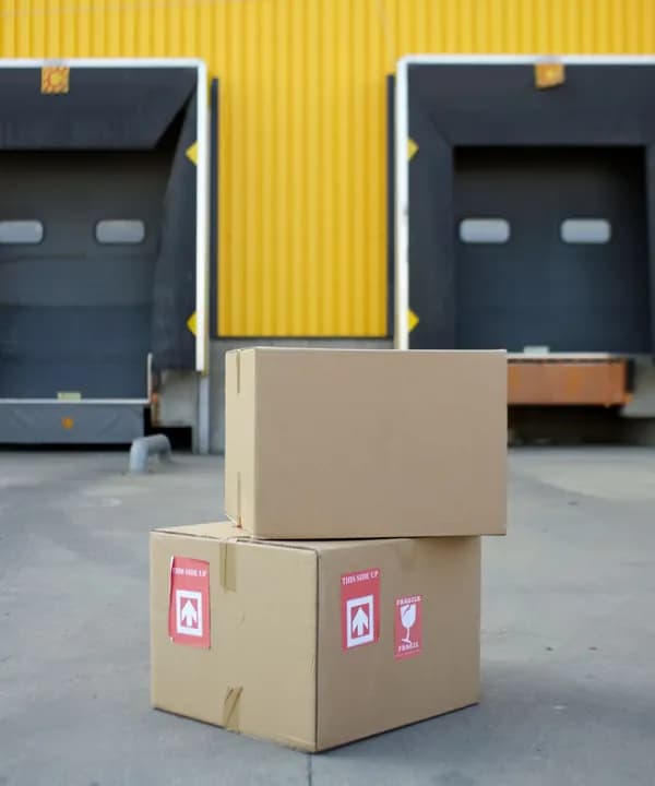 Cartons waiting at a yellow loading dock