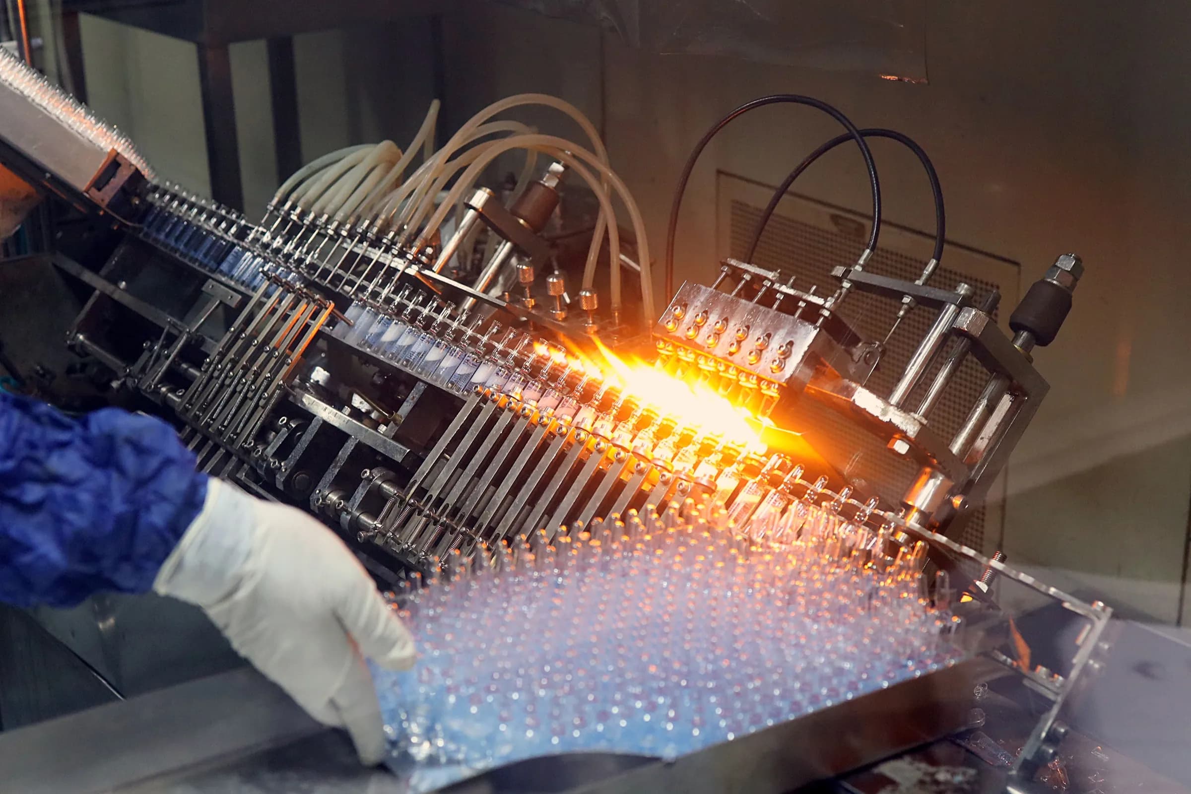 Glass ampoules being flame-sealed on a pharmaceutical line
